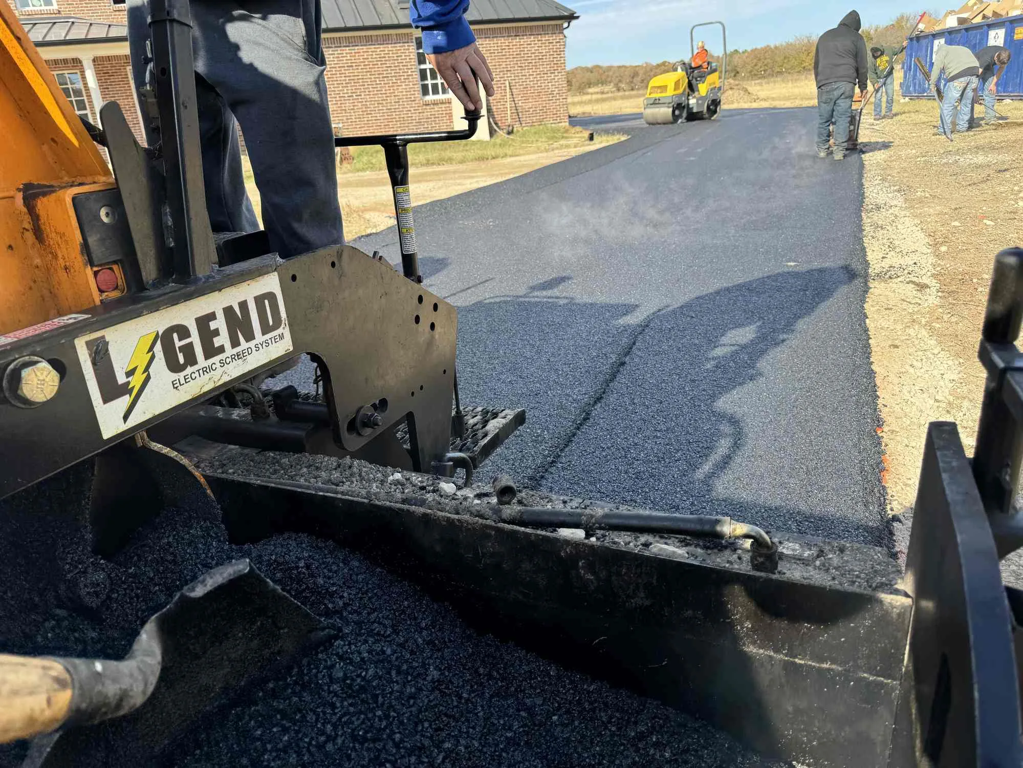Paving crew laying a driveway